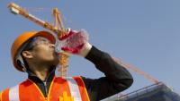 Construction worker drinking water